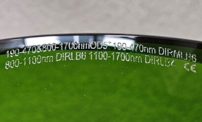 Close up of laser glass ratings on green laser glasses